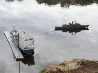 HMS Hermes and HMAS Toowoomba at the anchorage with man-made wharf