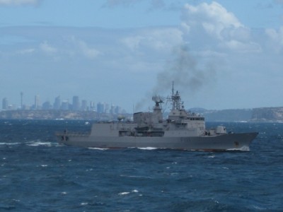 Te Mana passing the heads with the Sydney skyline in the background